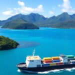 Freighter sailing near lush Austral Islands with turquoise waters.