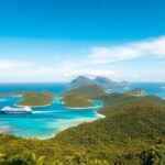 Freighter cruising through the lush Austral Islands.