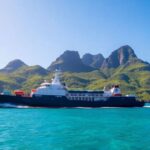 Tuhaa Pae Freighter in clear waters near lush islands.